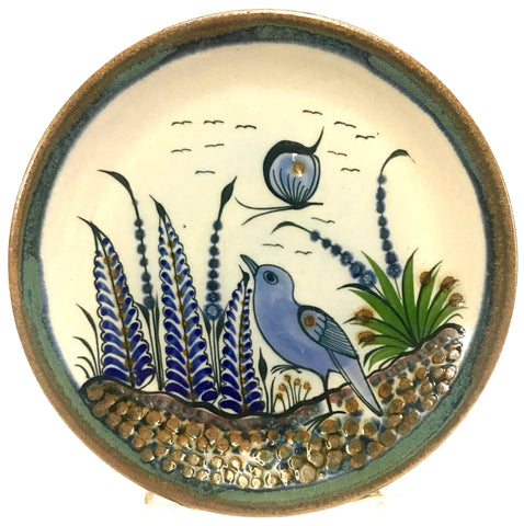 Ken Edwards Stoneware Pottery trivet with green, two shades of blue and brown flowers, birds, and butterflies decorated on the side or inside on bowls or plates
