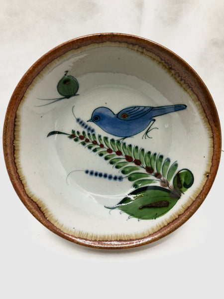 Ken Edwards bowl with a brown rim and a bird, butterfly, and leaf in the interior.