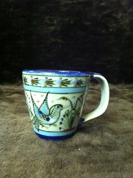 Ken Edwards Collection series Mug with  green, two shades of blue and brown flowers, birds, and butterflies decorated on the side or inside on bowls or plates