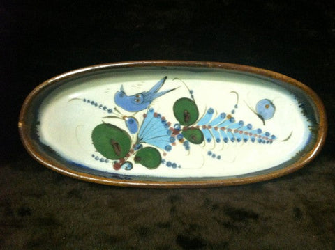 Long tray with brown rim and blue and green ornaments.