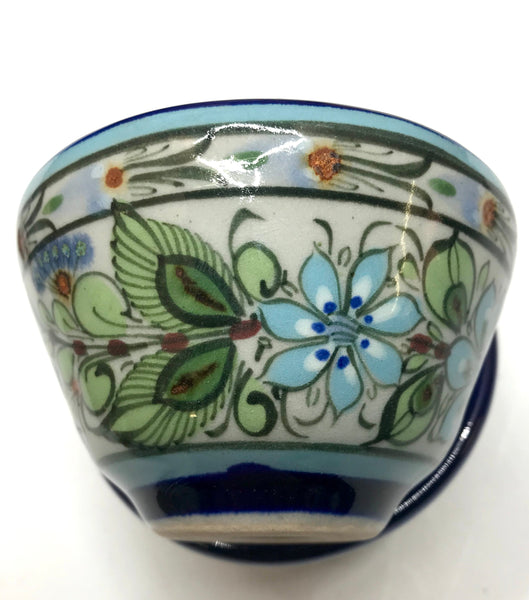 Ken Edwards collection series custard bown with blue rim. It is natural grey clay color background with birds, butterflies, and leaves in blue, green, black and brown on the outside.