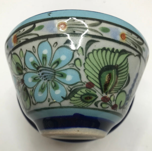 Ken Edwards collection series custard bown with blue rim. It is natural grey clay color background with birds, butterflies, and leaves in blue, green, black and brown on the outside.