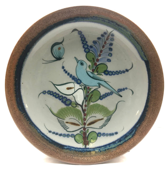 Ken Edwards Stoneware Pottery buffet plate with  green, two shades of blue and brown flowers, birds, and butterflies decorated on the side or inside on bowls or plates