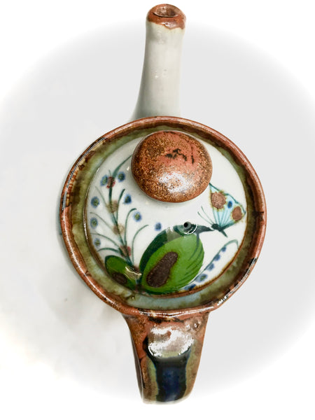 A large stoneware tea pot with brown rim and decorated with laves, bird, and butterlfy, 2 pieces