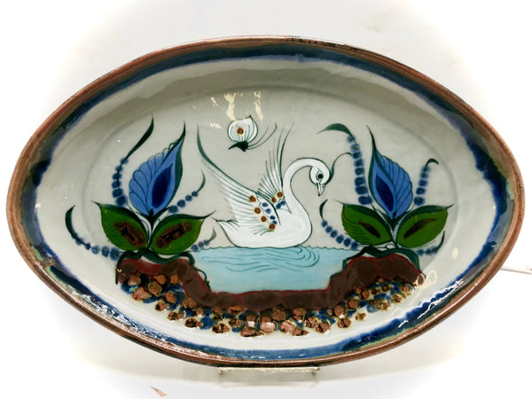 Oval platter with brown rim and bird and butterfly design inside.