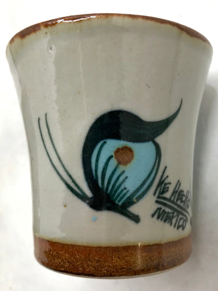 Ken Edwards stoneware mini drinking cup with green, two shades of blue and brown flowers, birds, and butterflies decorated on the side or inside on bowls or plates