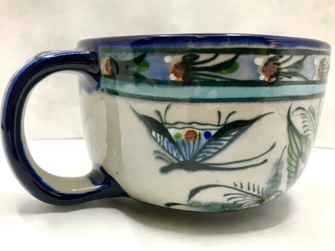 Ken Edwards Collection Series Latte Mug with  green, two shades of blue and brown flowers, birds, and butterflies decorated on the side or inside on bowls or plates