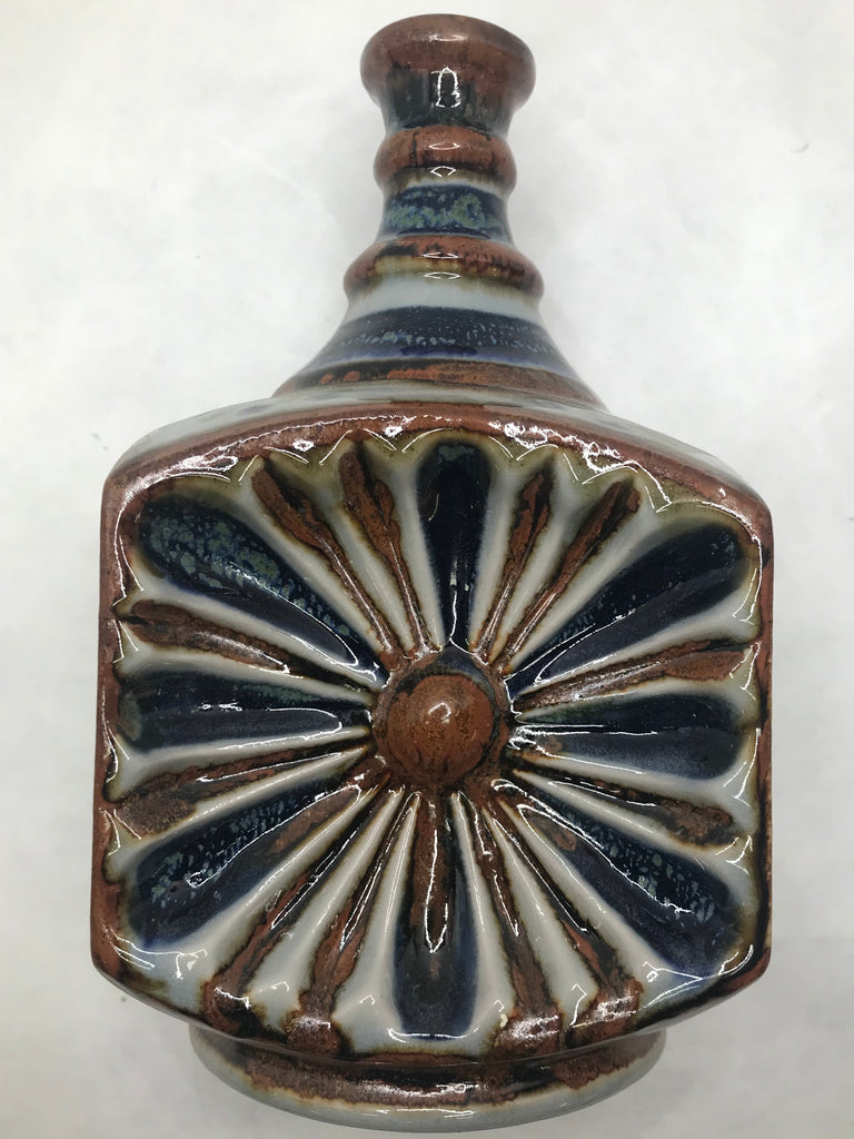 A bottle in a baroque design with brown and blue