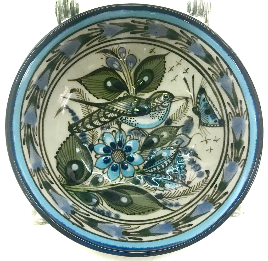 Desert bowl with blue rim with bird and flowers and a butterfly in the center.