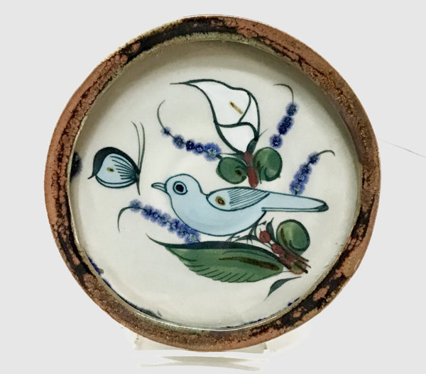 Ken Edwards round stoneware tray with green, two shades of blue and brown flowers, birds, and butterflies decorated on the side or inside on bowls or plates