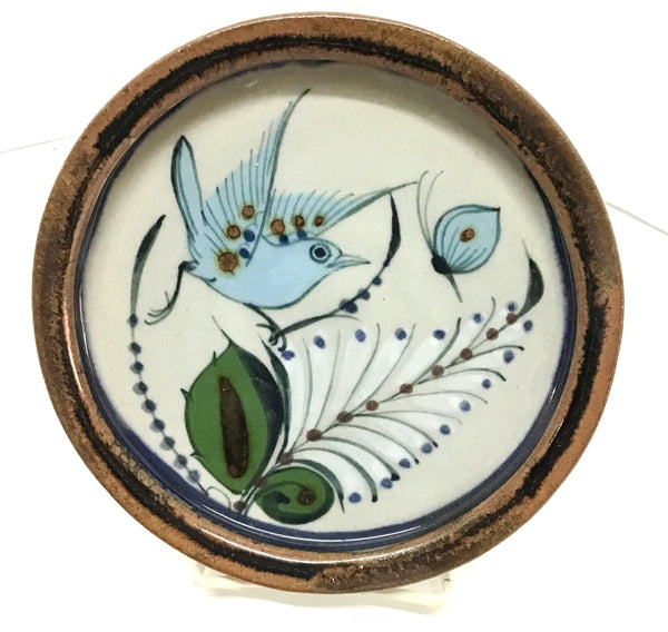 Ken Edwards round stoneware tray with green, two shades of blue and brown flowers, birds, and butterflies decorated on the side or inside on bowls or plates 