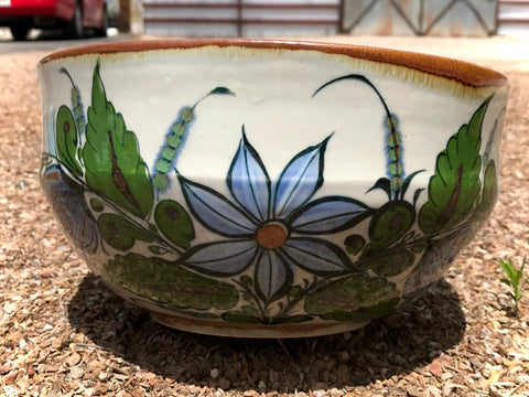 Stoneware bowl with brown trim and flower, bird, butterfly inside and out.