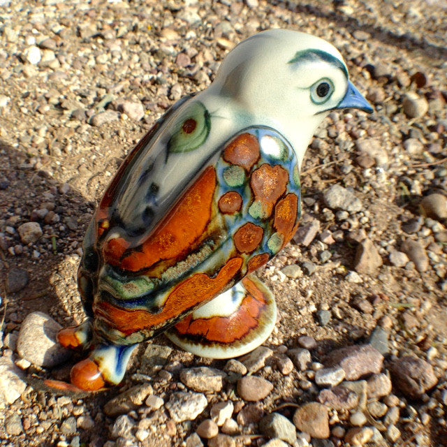 A bird figurine with brown wings