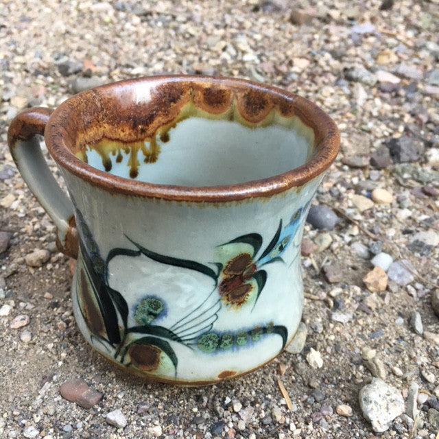 Ken Edwards Stoneware Pottery with brown rim and black, green, blue bird, butterfly, or leaves.